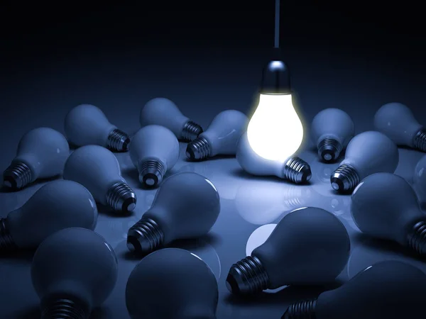 One glowing hanging light bulb standing out from the unlit dead incandescent bulbs with reflection , leadership and different business creative idea concept — Stock Photo, Image