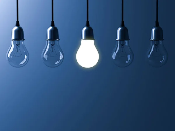 One hanging light bulb glowing different and standing out from unlit incandescent bulbs with reflection on dark blue background , leadership and different business creative idea concept — Stock Photo, Image