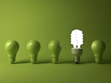 Eco energy saving light bulb , one glowing compact fluorescent lightbulb standing out from unlit incandescent bulbs reflection on green background , individuality and different concept . 3D render clipart