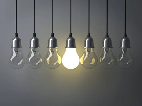 One hanging light bulb glowing different and standing out from unlit incandescent bulbs with reflection on dark grey background , leadership and different business creative idea concept — Stock Photo, Image