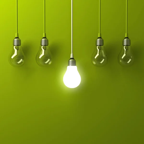 One hanging light bulb glowing different and standing out from unlit incandescent bulbs with reflection on green background , leadership and different business creative idea concept . 3D render — Stock Photo, Image