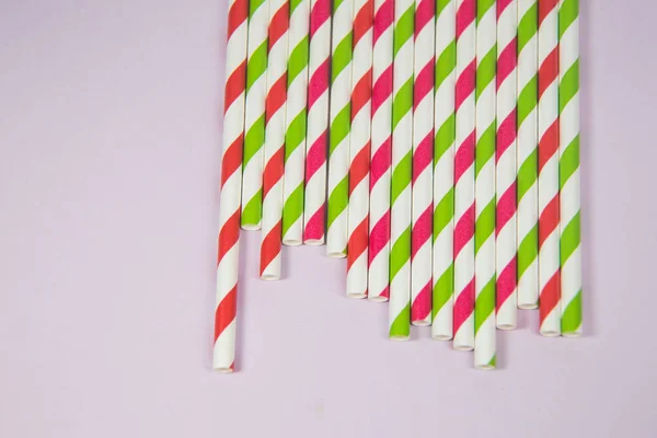 Multicolored straws on the pink background — Stock Photo, Image