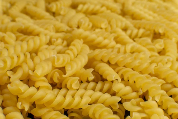 Fondo formado por pasta en forma de espiral. textura . — Foto de Stock