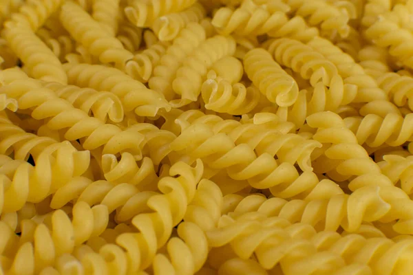 Fondo formado por pasta en forma de espiral. textura . — Foto de Stock