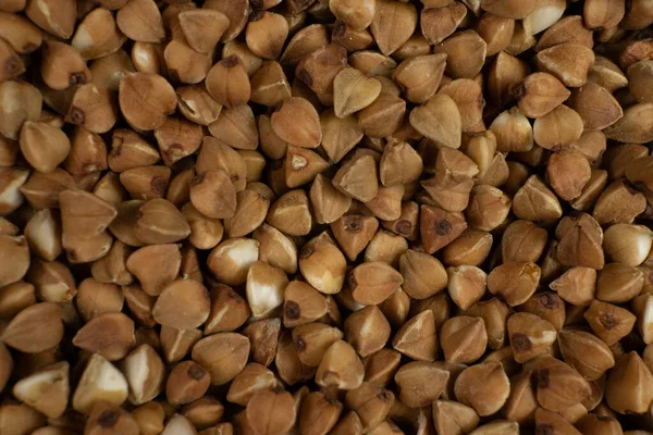 Sfondo e consistenza del grano saraceno. Grano saraceno arrosto. Guarnire. Ingrediente. Prodotti dietetici . — Foto Stock