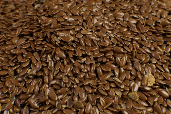 Brown Flax seed. Also known as Linseed, Flaxseed and Common Flax. Closeup of grains, background use.
