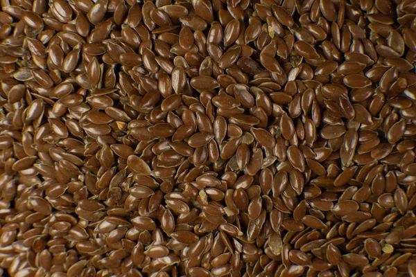 Semilla de lino marrón. También conocido como Linaza, Linaza y Lino Común. Primer plano de los granos, uso de fondo . —  Fotos de Stock