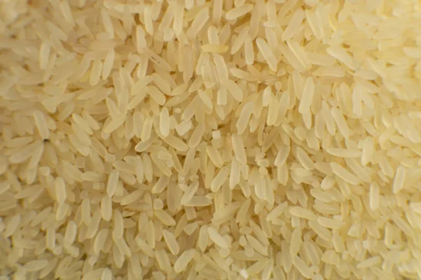 Long grain white rice background. Macro. Rice texture. Top view — Stock Photo, Image