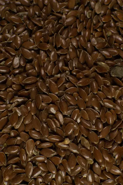 Semi di lino marrone. Conosciuto anche come seme di lino, semi di lino e lino comune. Primo piano dei chicchi, uso di fondo . — Foto Stock