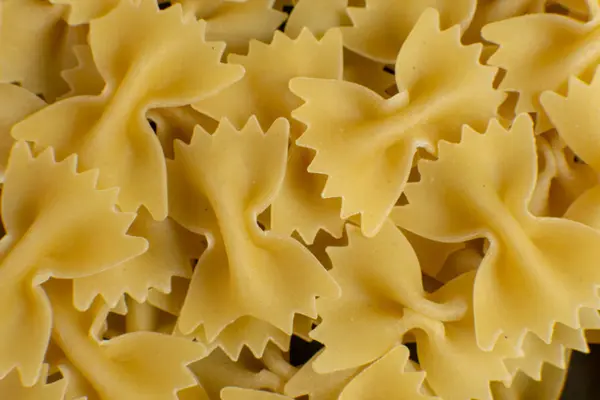 Hintergrund einiger Farfalle Pasta in Form von Bögen. Muster — Stockfoto