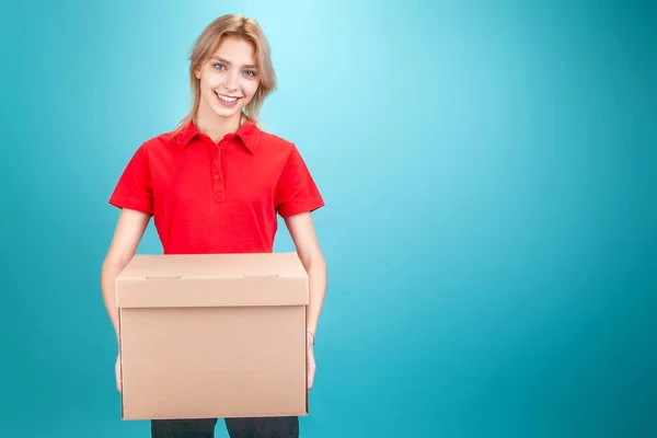 blonde girl in a red shirt and a box in her hands