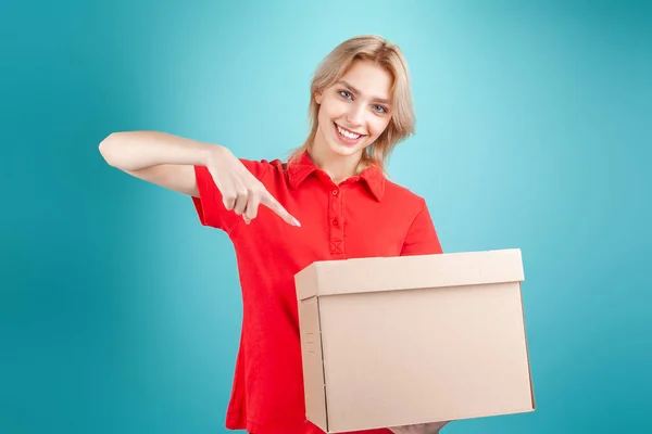 blonde girl in a red shirt and a box in her hands