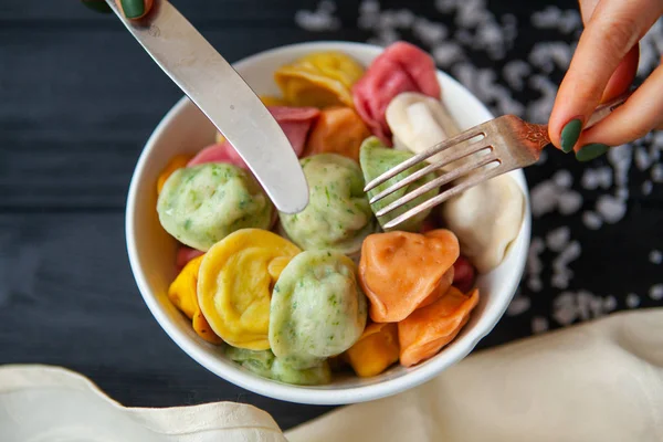 stock image cooked dumplings of different colors in a white plate