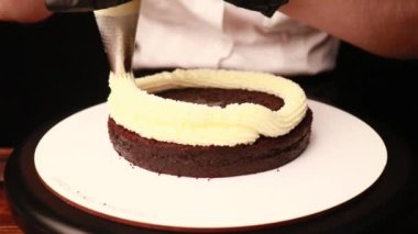 Siyah eldivenli kadın eli kek pişirmek.