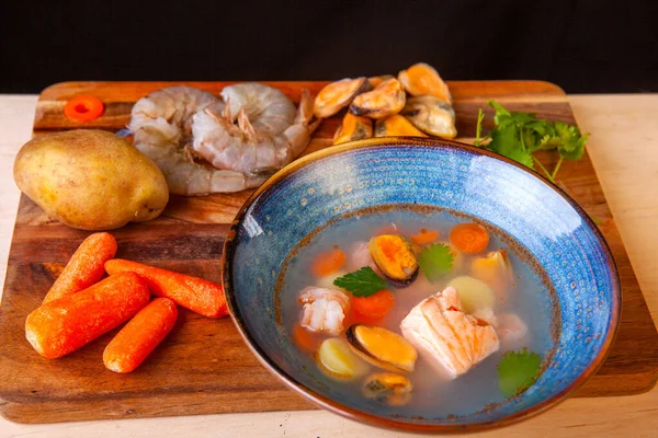 Soup in a plate and ingredients included in it on a wooden board — Stock Image Soup Plate Ingredients Included Wooden Board Stock Picture