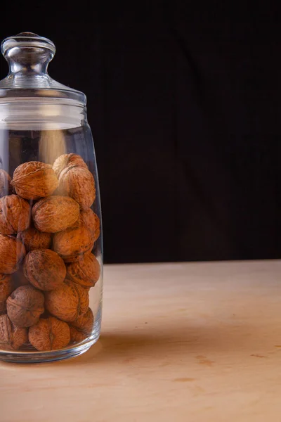 nuts in a glass bowl on a table in the studio