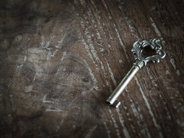 Classic Old Antique Key on Grunge Wooden Background