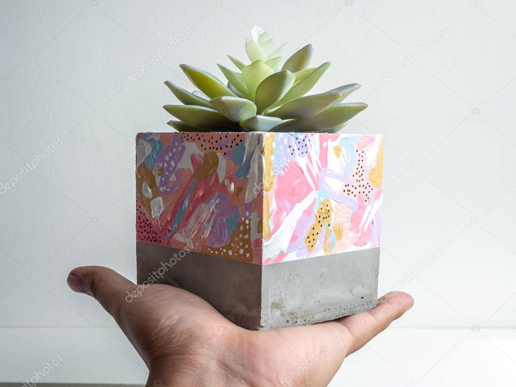 Modern geometric concrete planter. Beautiful painted concrete po