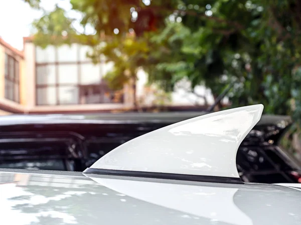 Antenna shark fin shape white color decorate on car roof. — Stock Photo, Image