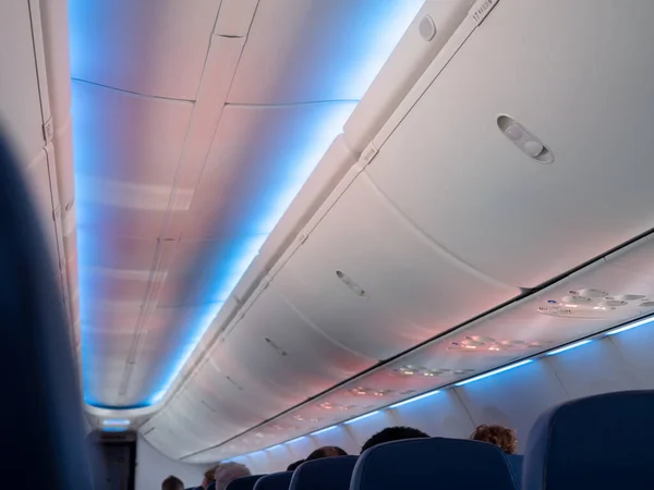 Hand luggage compartment in cabin economy class on the low cost commercial airplane.