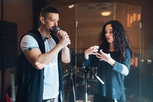 Musical teacher coaching a young male vocalist — Stock Photo, Image