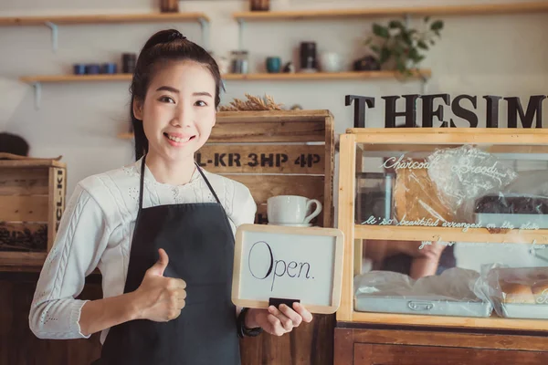 Portrait Asian woman business owner with bakery shop background