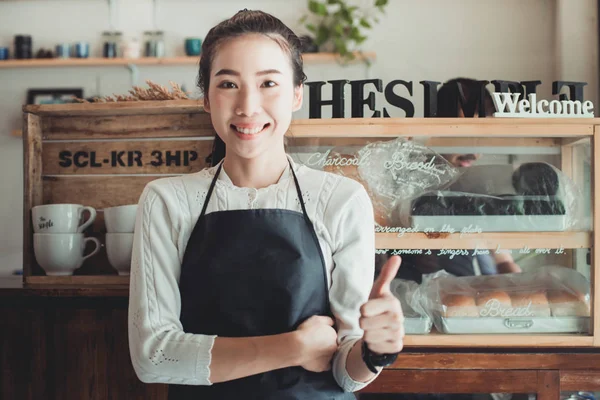 Portrait Asian woman business owner with bakery shop background