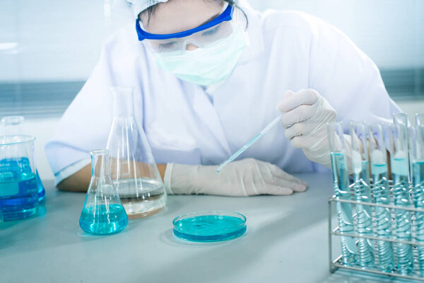 Female scientist analyzing sample in laboratory