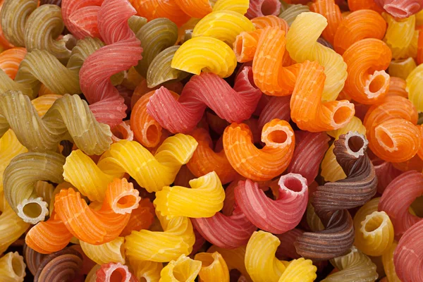 Mehrfarbige Trockene Wirbel Pasta Nahaufnahme Ansicht Hintergrund — Stockfoto