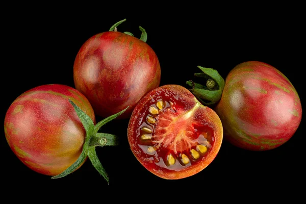 Brown cherry tomatoes colseup isolated on black background