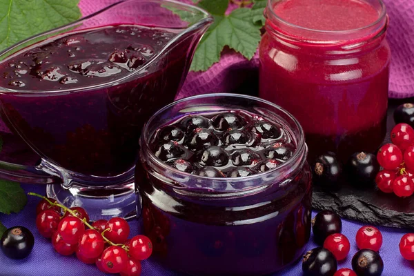 Closeup black and red currant jam in glass