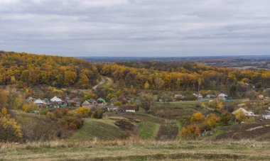 Autumnal landscape with small remote hamlet Kharkivshchyna in Sumskaya oblast, Ukraine clipart