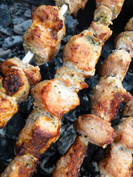 Close view on pork meat cooked outdoor on metal skewers — 스톡 사진