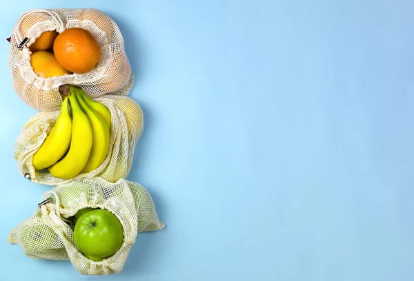 Fruit Bananas Apples Oranges Caton Mesh Bags Blue Background Zero — Stock Photo, Image