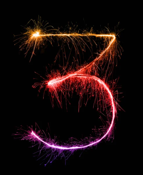 3 dígitos tres hechos de bengalas de fuegos artificiales en la noche —  Fotos de Stock
