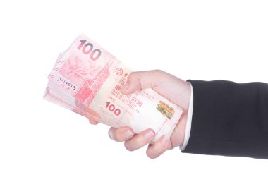 Hong Kong Doları para üzerinde beyaz izole ile takım elbiseli el