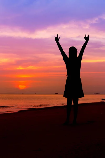 Silhouette of woman with hands up and showing I LOVE YOU sign on — Stock Photo, Image