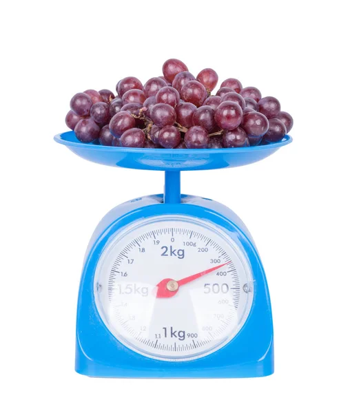 Grapes on kitchen scale isolated on white background — Stock Photo, Image