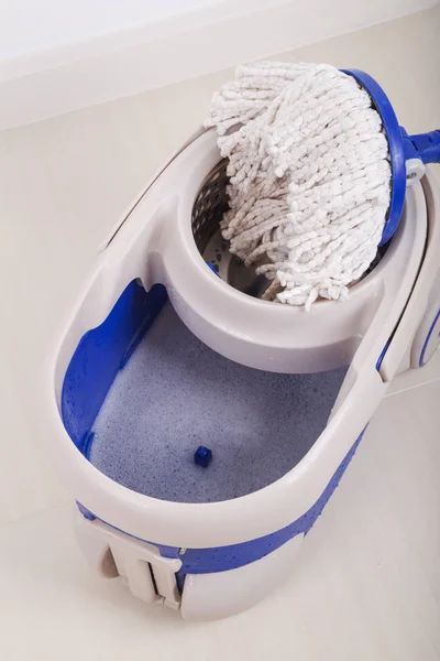 Close up of mop and blue bucket for cleaning floor — Stock Photo, Image