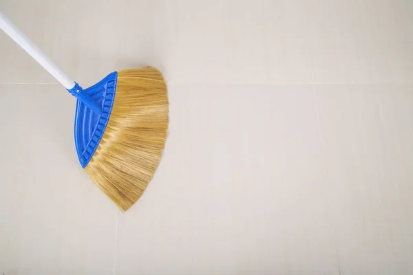 Broom on floor background — Stock Photo, Image