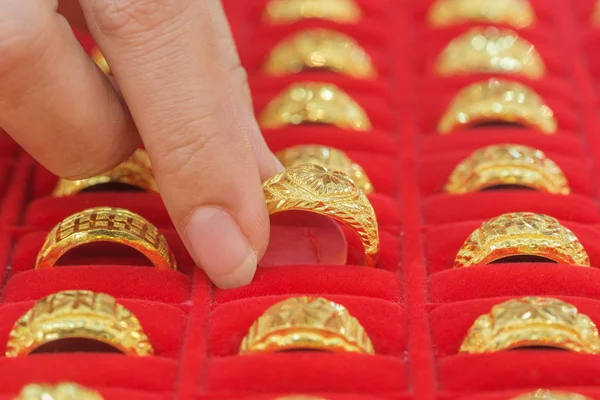 hand choosing gold rings