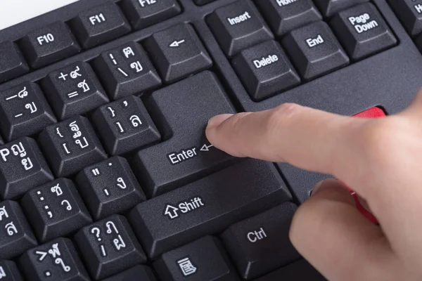 Finger pushing enter button on keyboard of computer — Stock Photo, Image