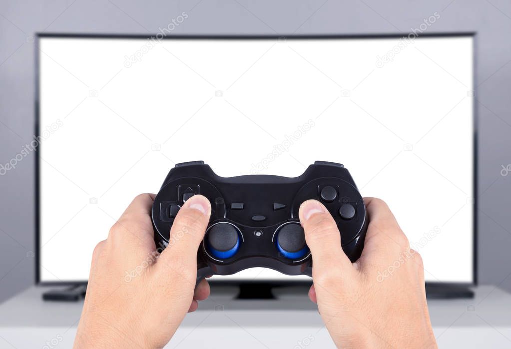 hand holding joystick to playing video game on tv (blank screen)