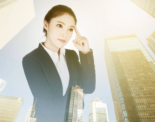 Double exposure of  business woman thinking with city background — Stock Photo, Image