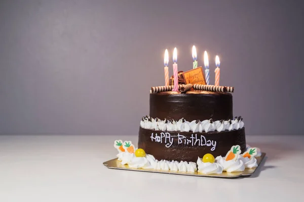 Chocolate cake with birthday light candle — Stock Photo, Image