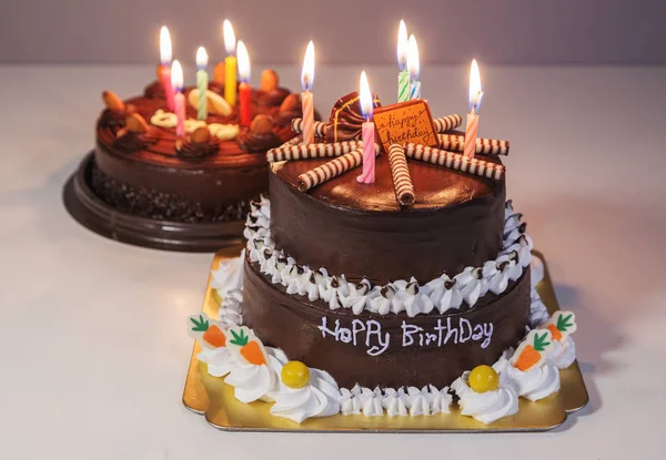 Chocolate cake with happy birthday light candle — Stock Photo, Image