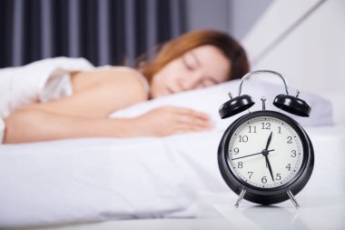 yatakta uyuyan kadın ile saat 