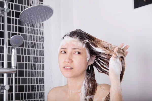 Unglückliche Frau wäscht Kopf mit Shampoo und Dusche — Stockfoto