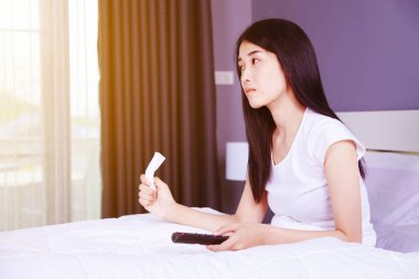 Uzaktan kumandalı yatak yatak odasında TV izlerken ağlayan kadın