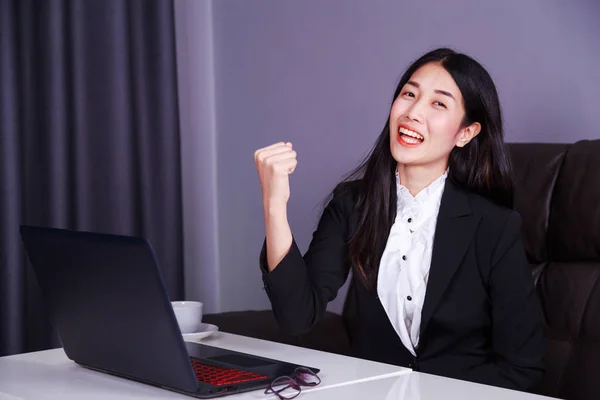 Successful business woman raising arm in happiness with laptop c — Stock Photo, Image